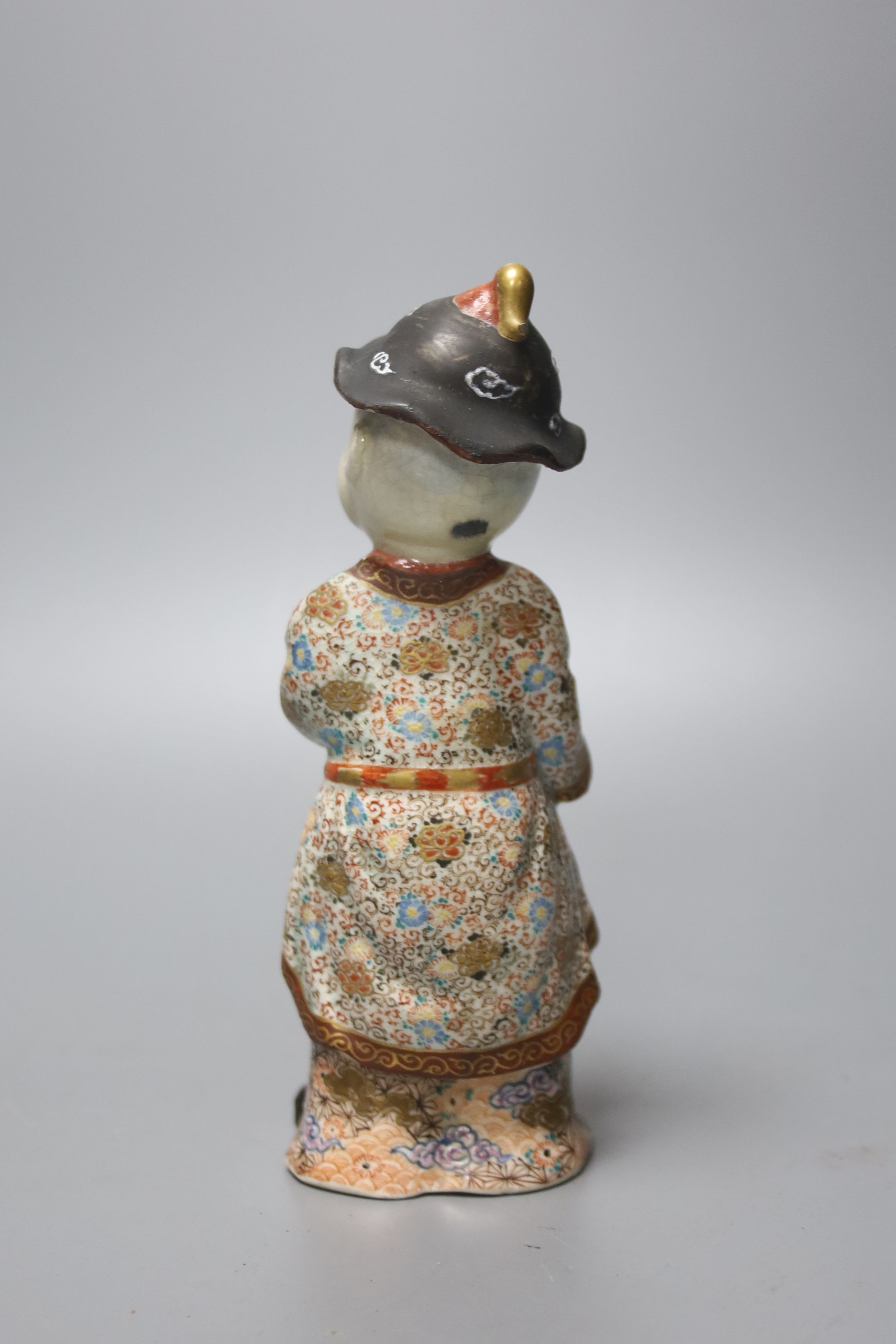 A 19th century Japanese Imari box and cover and a Satsuma pottery figure of a boy holding a Daruma doll, tallest 20cm